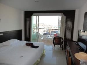 Baan Manthana Hotel bed and balcony view