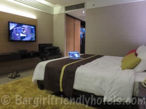 Superior room seen from side of bed with big LCD TV on display in DoubleTree by Hilton Bangkok Ploenchit