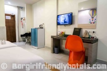 Deluxe room features like big fridge and TV at the Grand Bella Hotel