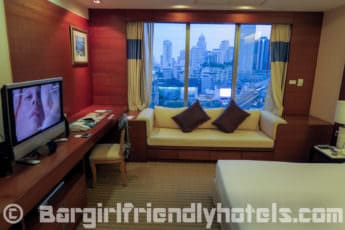 Bedroom with a view over the Asoke Skytrain station in Jasmine City Hotel