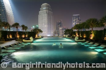going in for a quick dip in the infinity swimming pool at night in Grande Centre Point Hotel Terminal 21