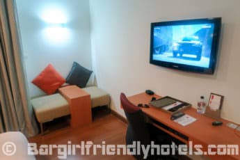 closer-look-at-room-amenities-which-include-small-couch-and-desk-with-flatscreen-tv-inside-hotel-solo-sukhumvit-2