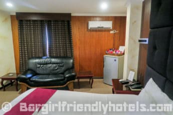 superior-rooms-have-a-couch-and-a-big-fridge-on-the-side-of-the-bed-in-hotel-royal-amsterdam-angeles-city